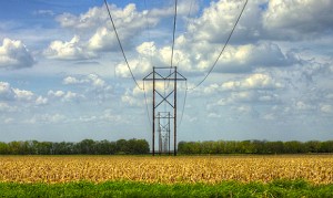 A transmission line crosses a field near Lawrence, Kansas. (Photo by David DeHetre via Creative Commons)